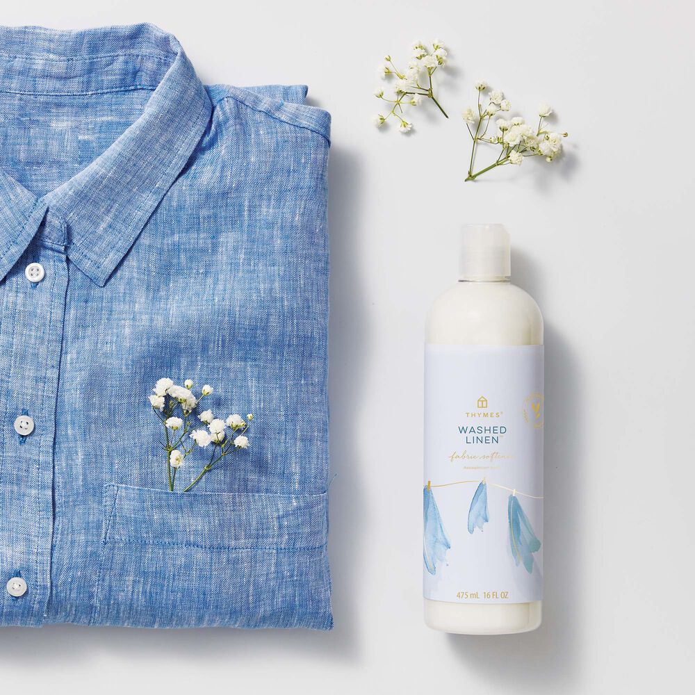 Thymes Washed Linen Fabric Softener for Soft Fabric next to blue shirt and baby's breath flower image number 1
